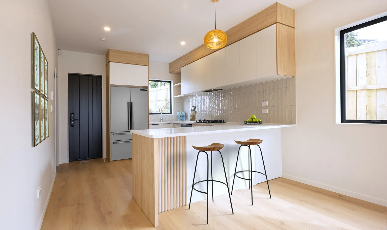 Kitchen with engineered stone benchtop in an Eden Group home at 12-14 Taupo Street, Green Bay.