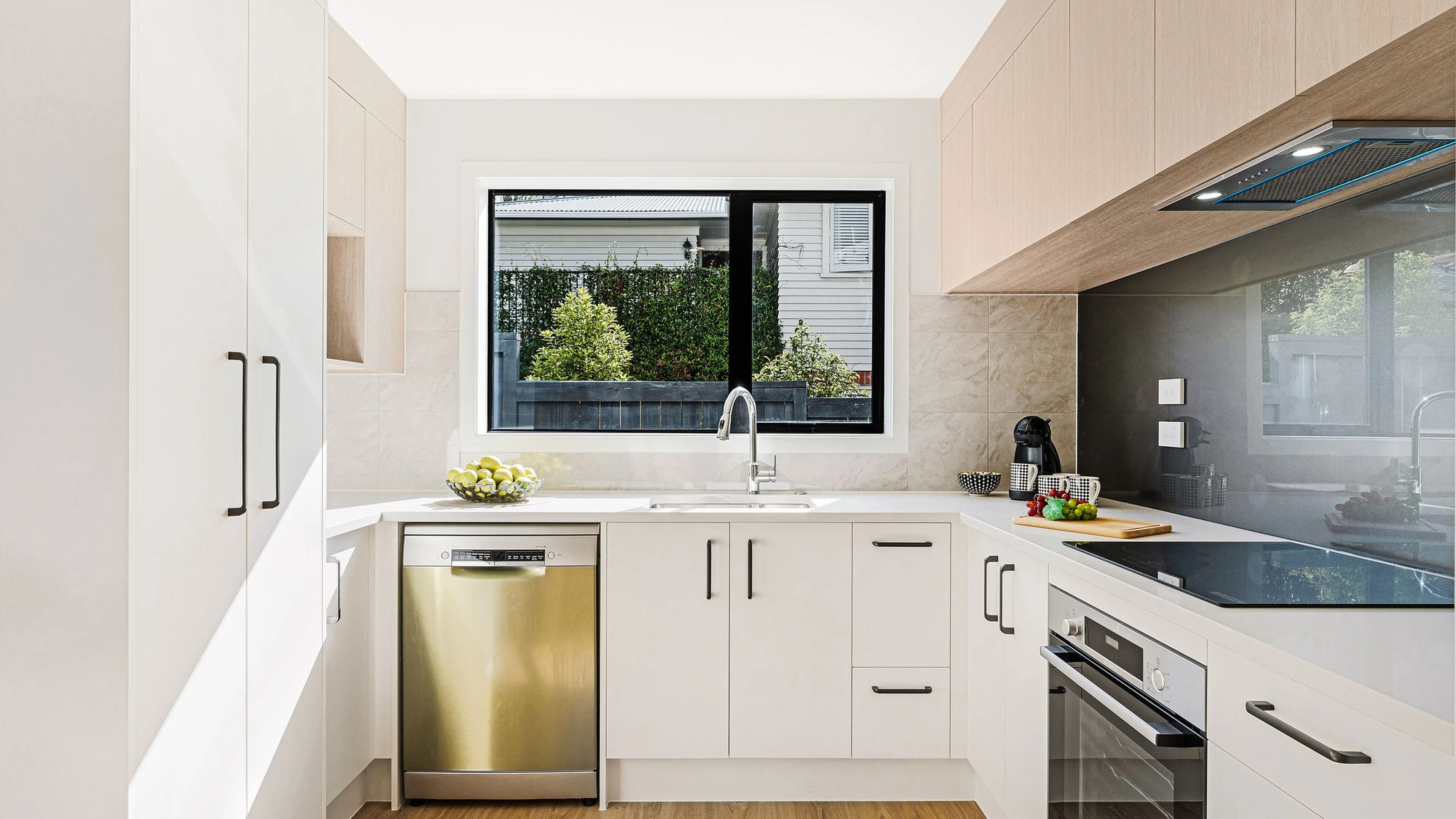 Kitchen with engineered stone benchtop in an Eden Group home at Woodward Avenue, Mangere Bridge