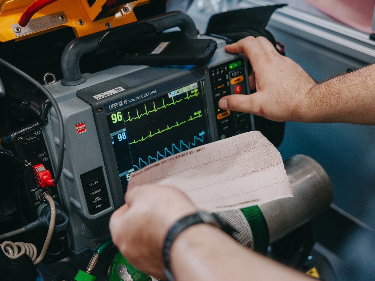 A Stark County Ambulance paramedic operating a cardiac monitor inside a unit