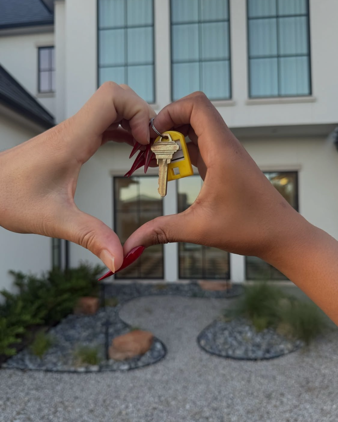 A homebuyer being handed the keys to their new home