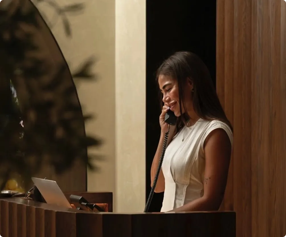 Receptionist answering a phone call at the front desk