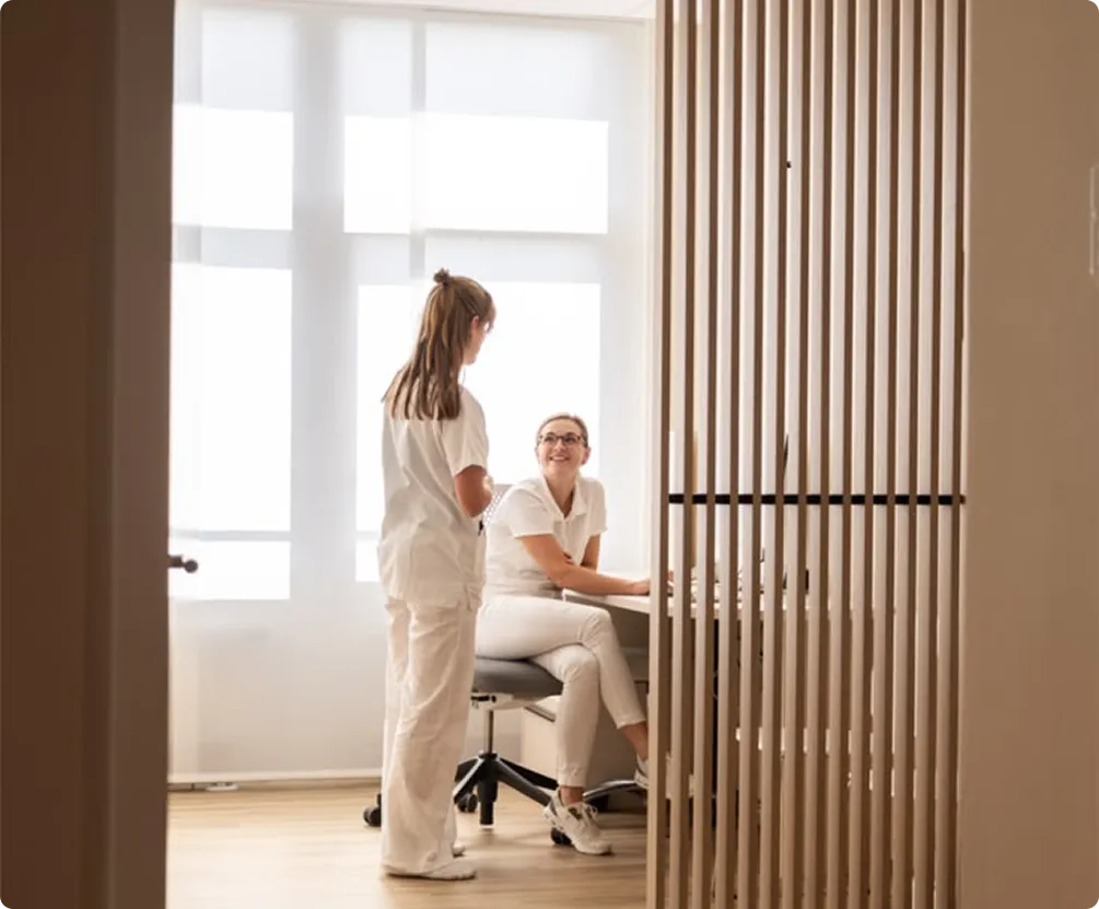 Healthcare staff talking in a bright clinic office