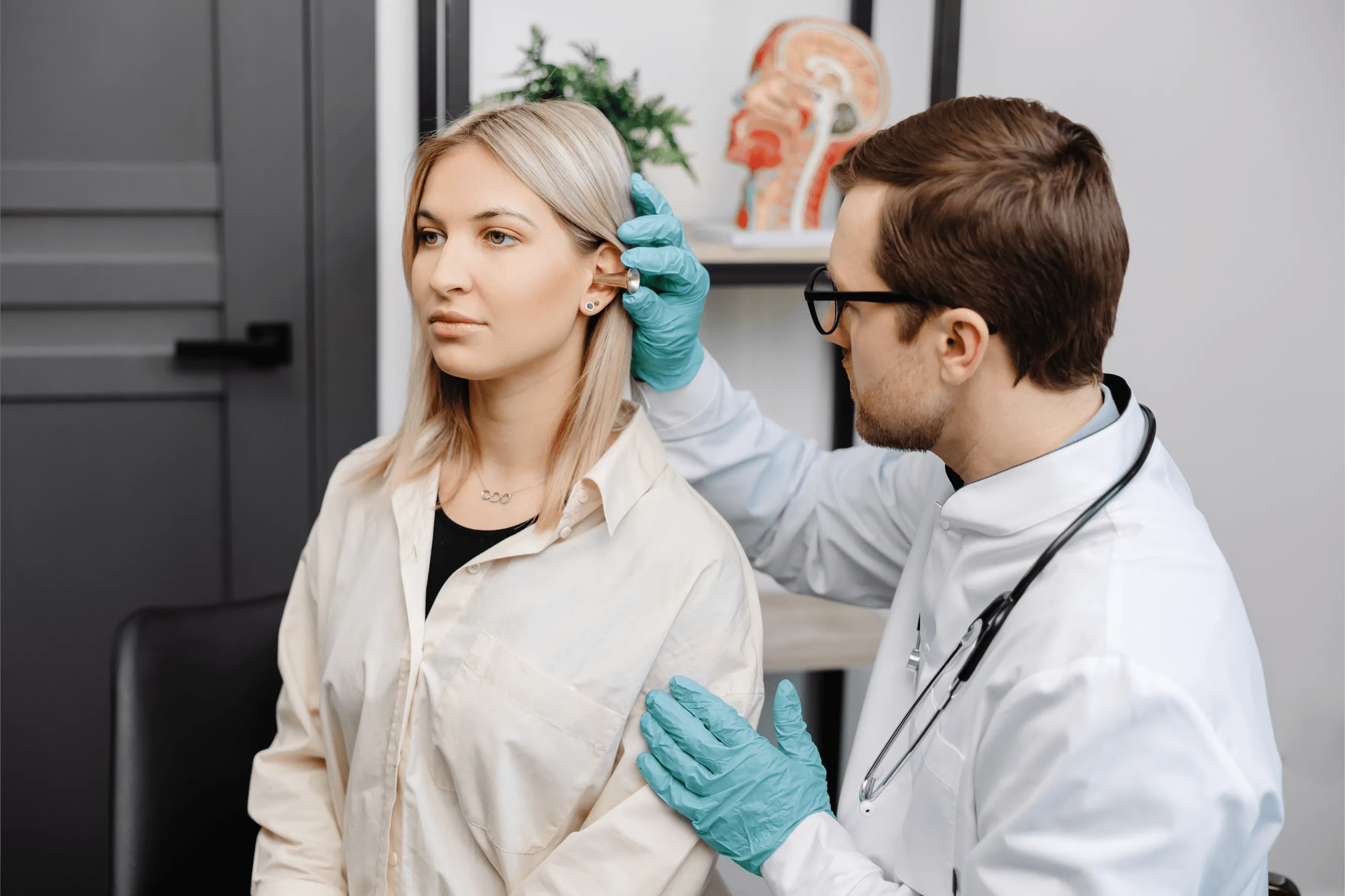 otolaryngologist checking a patient's ear