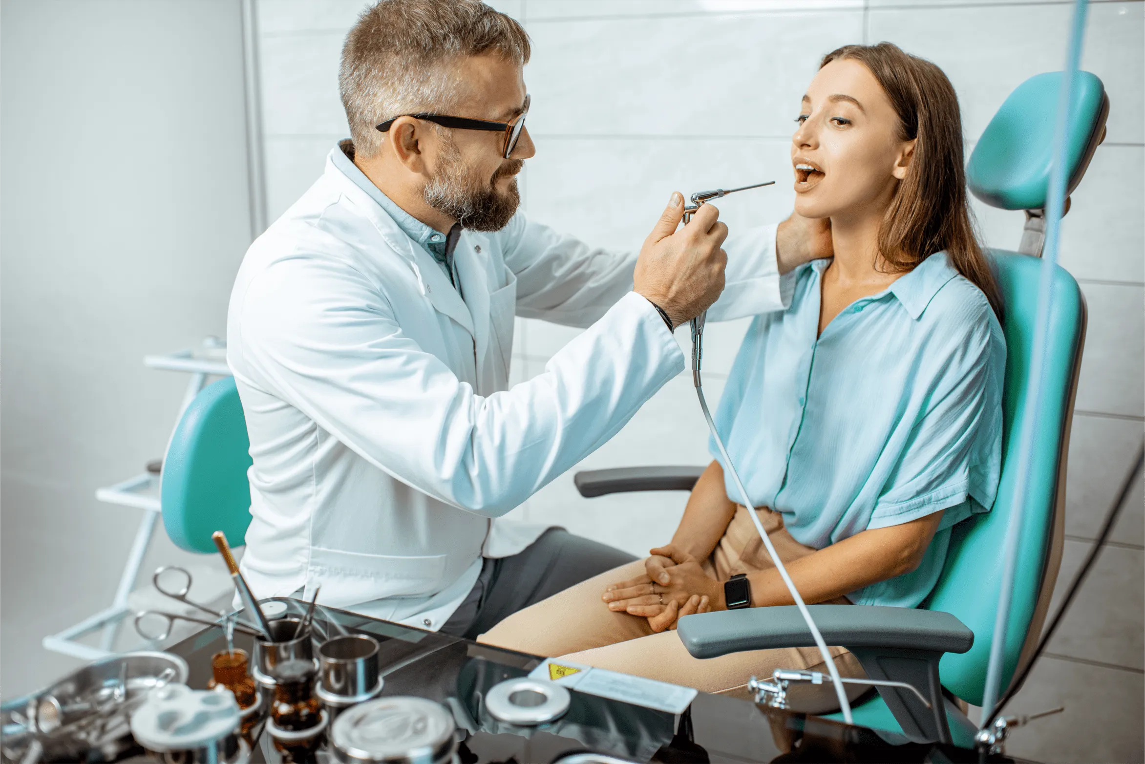otolaryngologist working with his patient