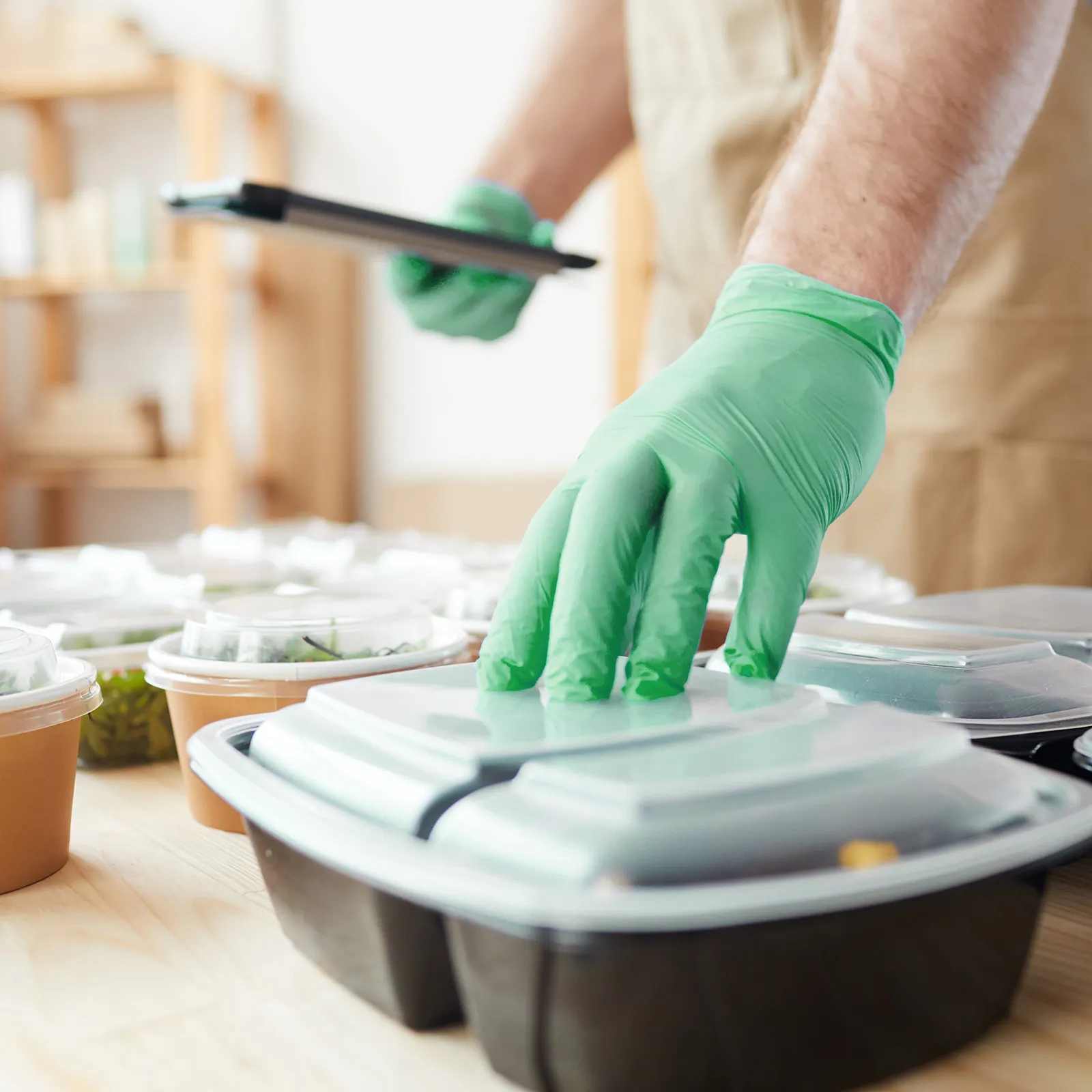 food in packaging checked by man with gloves