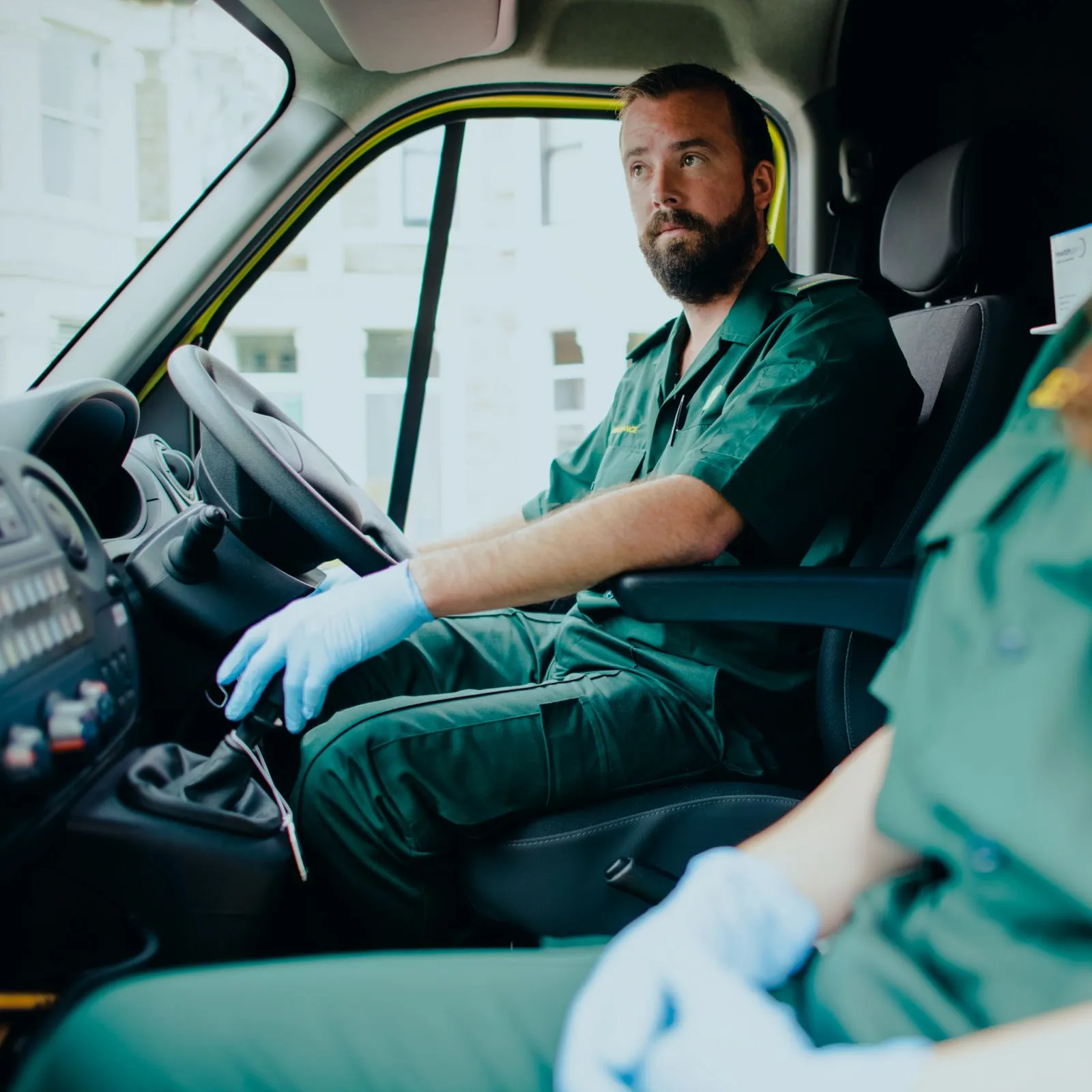 A man in a green uniform in an ambulance