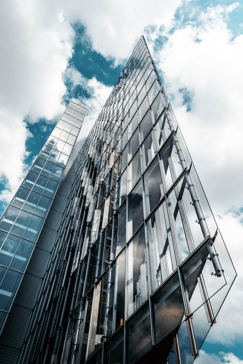 Low-angle view of a high-rise glass building, photograph by Christian Wiediger on Unsplash