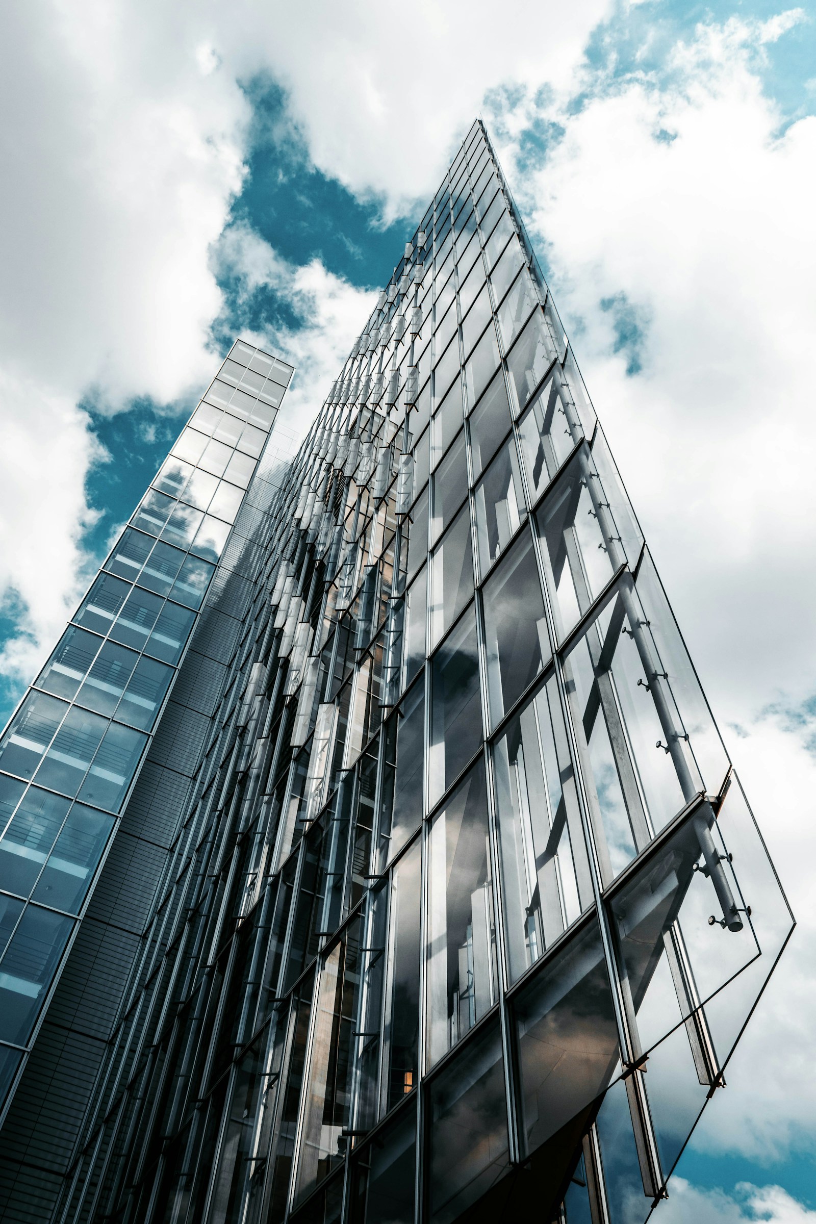 Low-angle view of a high-rise glass building, photograph by Christian Wiediger on Unsplash