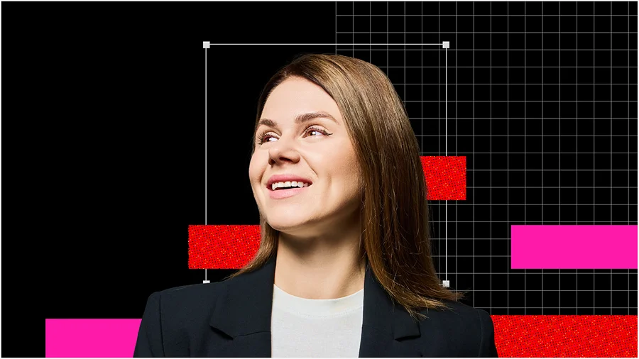 Smiling businesswoman in a black blazer looks upward against a black grid, with bright pink and red geometric accents creating a modern tone.