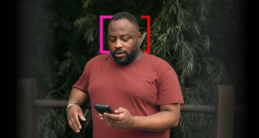 Man in a red shirt checks his smartphone outdoors, framed by pink and red brackets; overlay asks about reviewing 401(k) contributions.