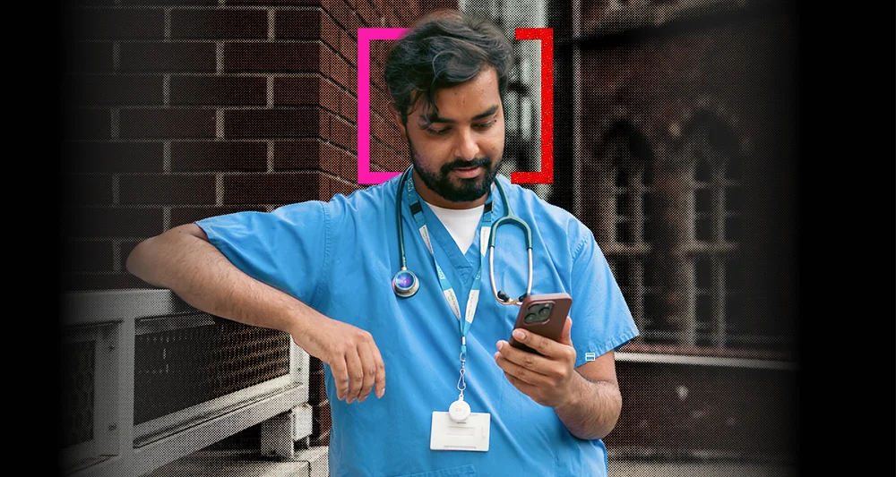 Male doctor in blue scrubs checks his smartphone beside a hospital window, with a graphic showing a home-buying action plan and 25% progress.