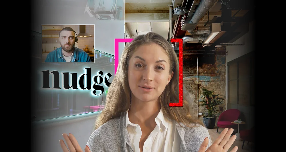 Video call scene with a woman speaking in an industrial office, a man in a picture-in-picture window, neon brackets, and call controls.
