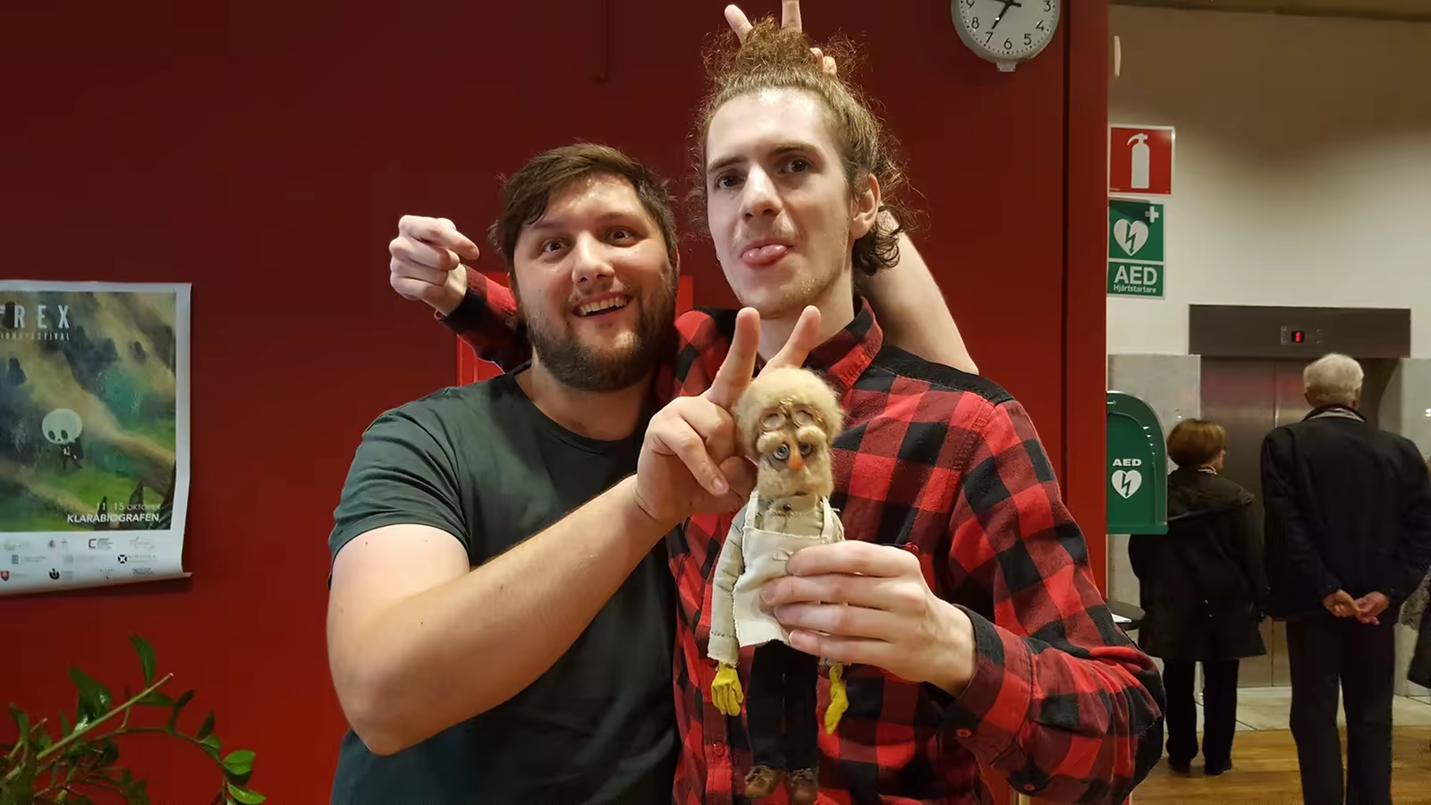 Two festival guests posing with a puppet