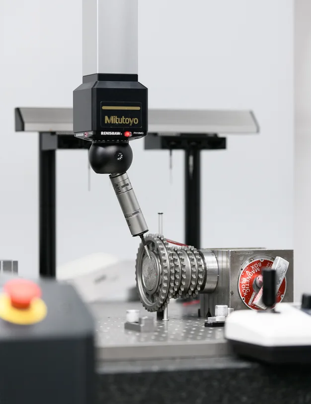 Coordinate measuring machine probe inspecting a timing gear