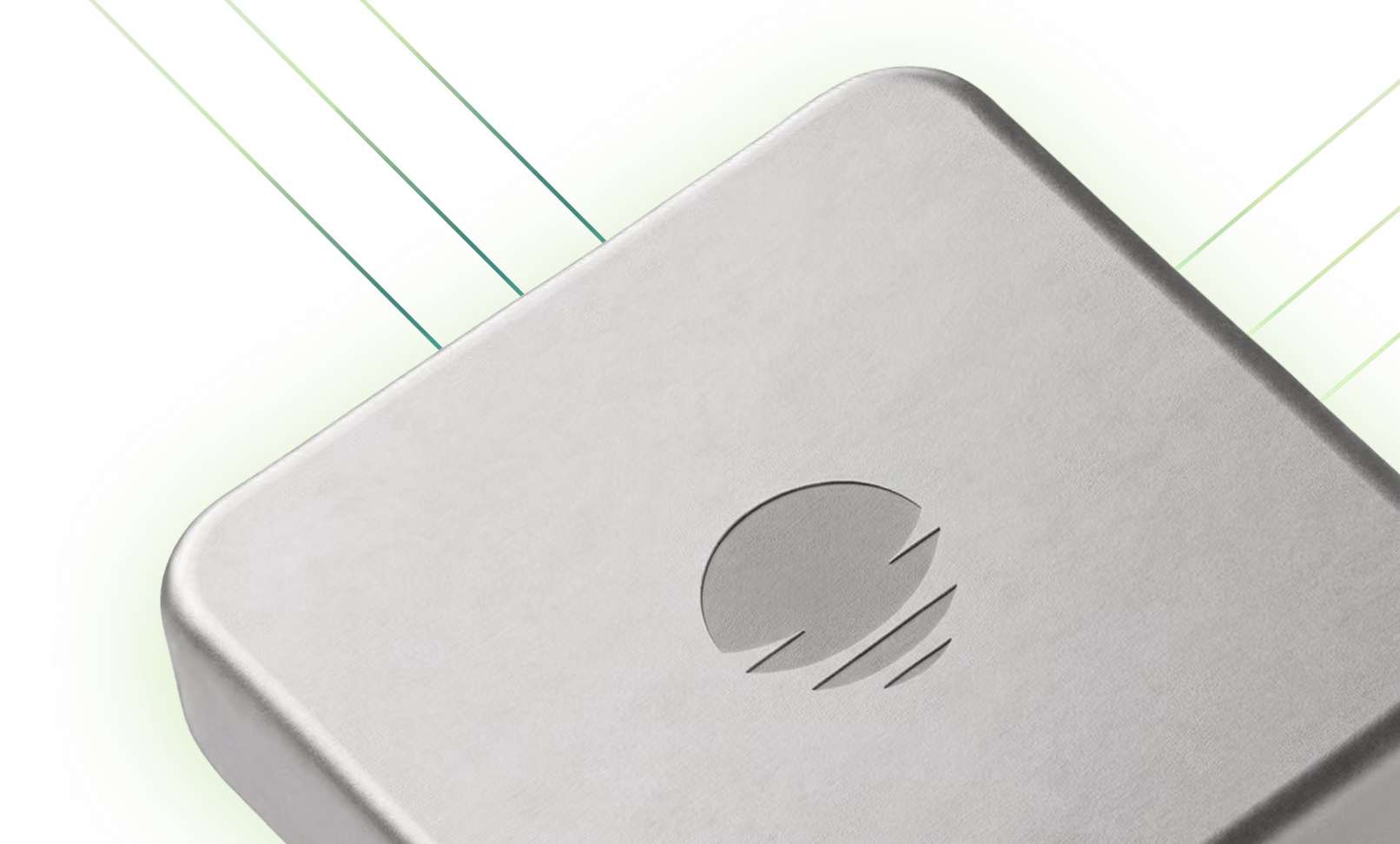 Close-up of a silver rectangular device with rounded corners and a carved circular logo in the center.