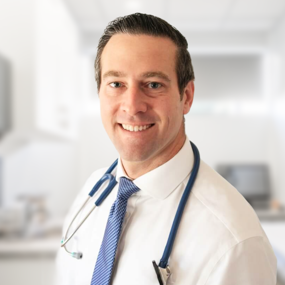 Dr. Matthew Mavroson reviewing clinical care plans for Doctor Skinny Shot patients.