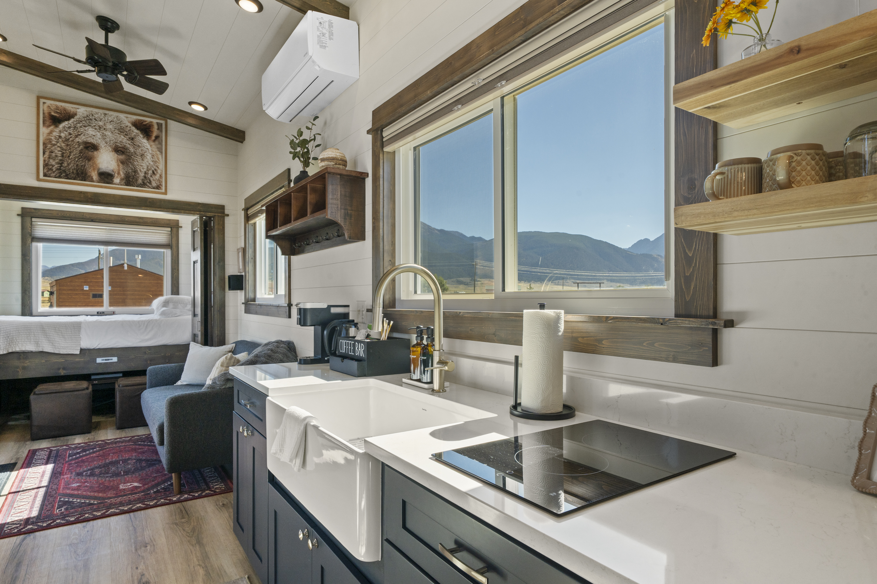 Royal Wulff kitchen with a farmhouse sink, induction cooktop and mountain-view window, looking toward the living room and bed