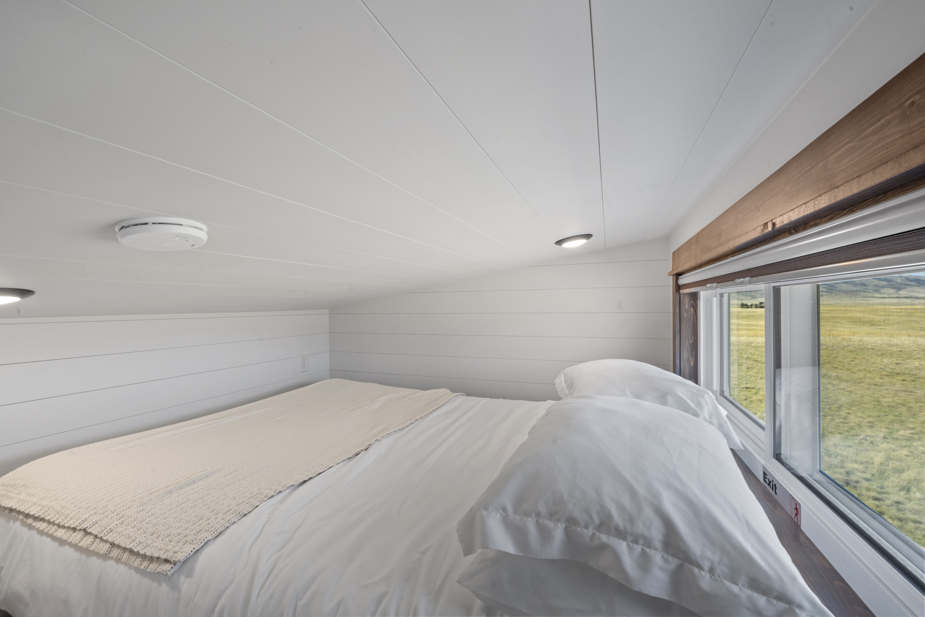 Royal Wulff loft queen bed with a long window overlooking open range