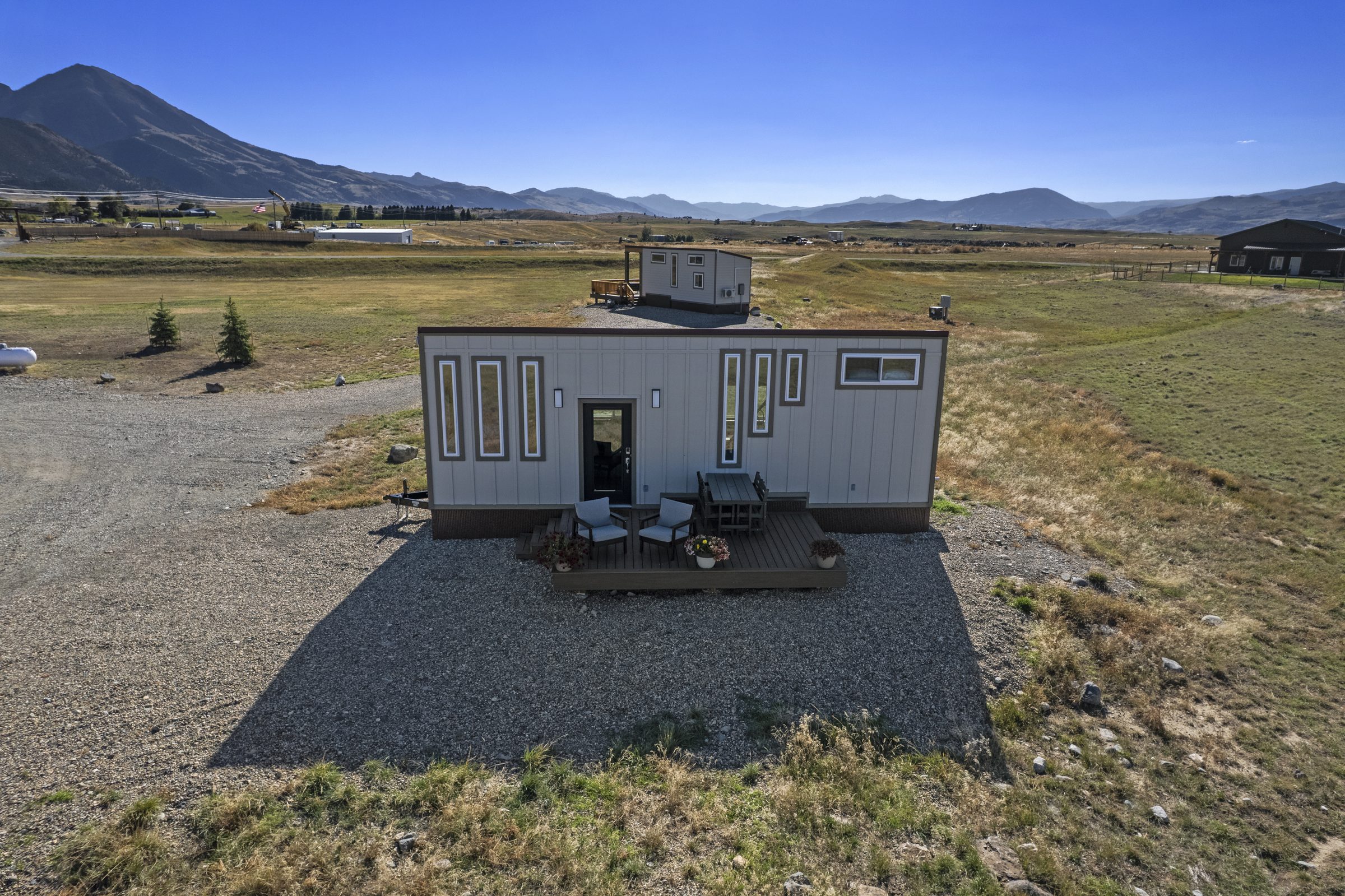 Aerial view of the Royal Wulff tiny home in front, the Green Drake behind it, and mountains in the distance