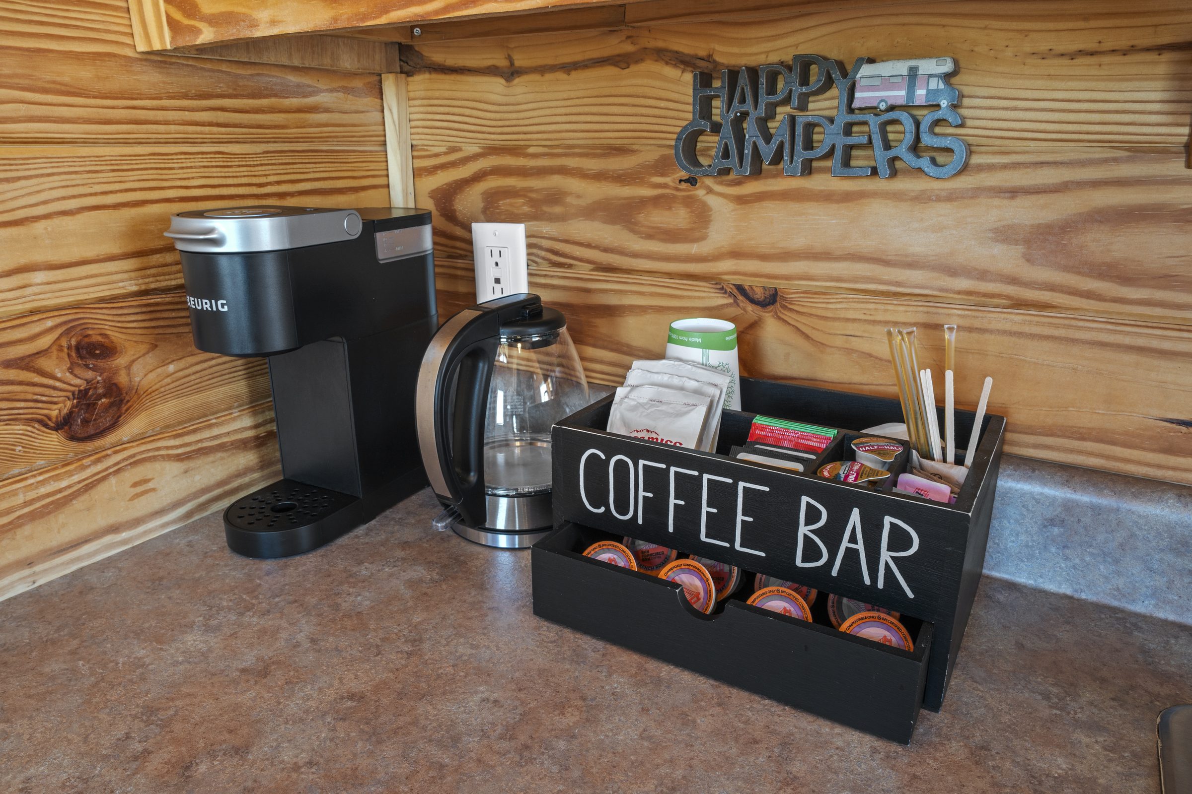 Keurig, electric kettle and a stocked coffee bar on the cabin counter