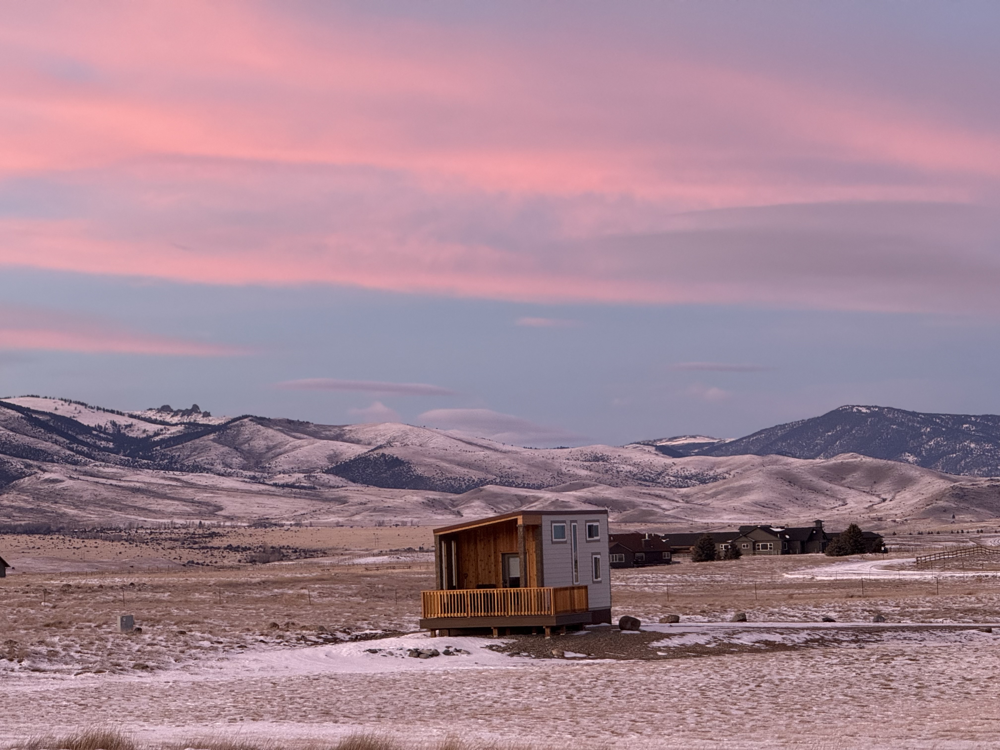 One of the tiny homes in winter, with snow on the ground around it