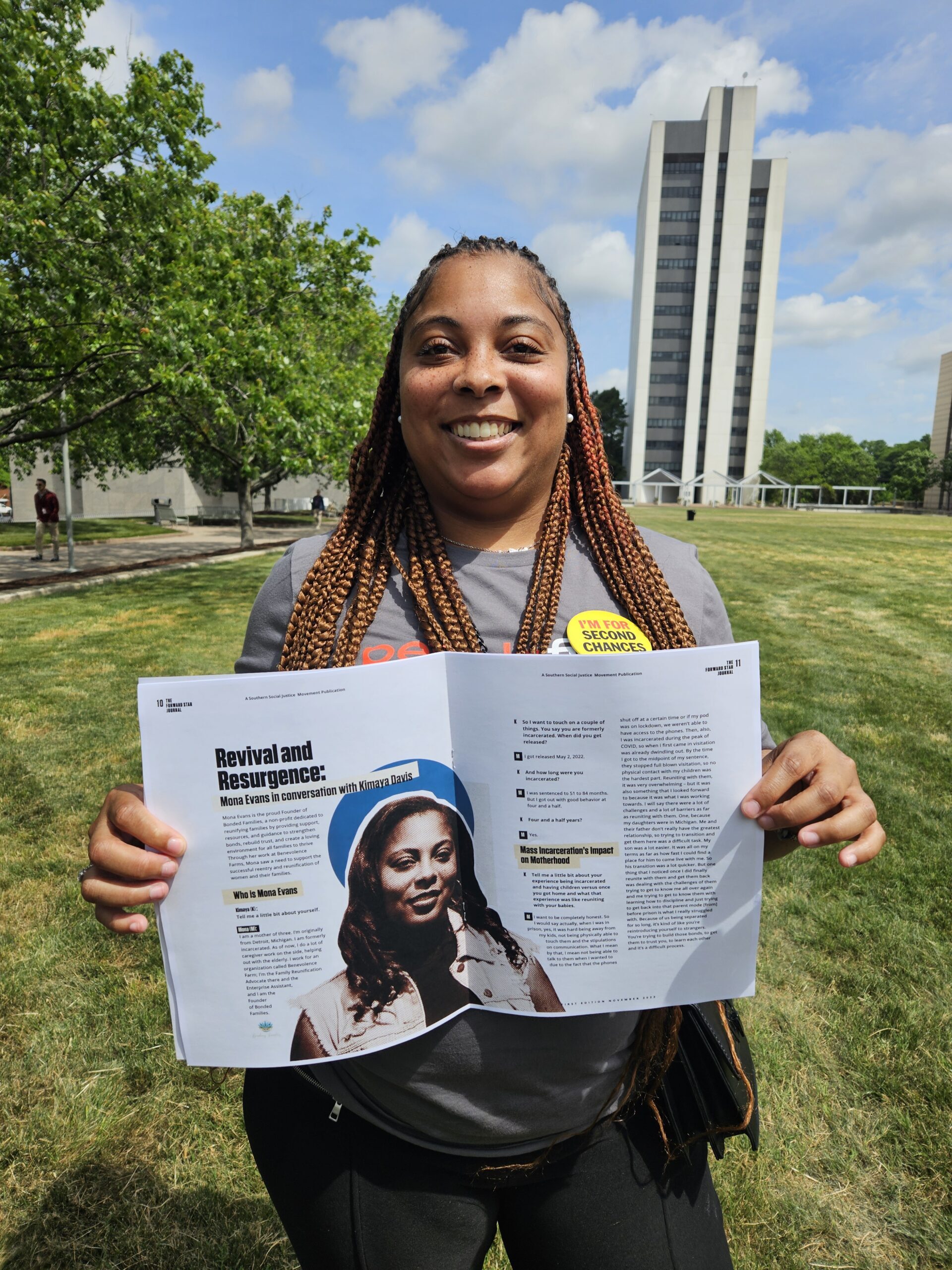 A Benevolence Farm staff member holding a magazine featuring her story