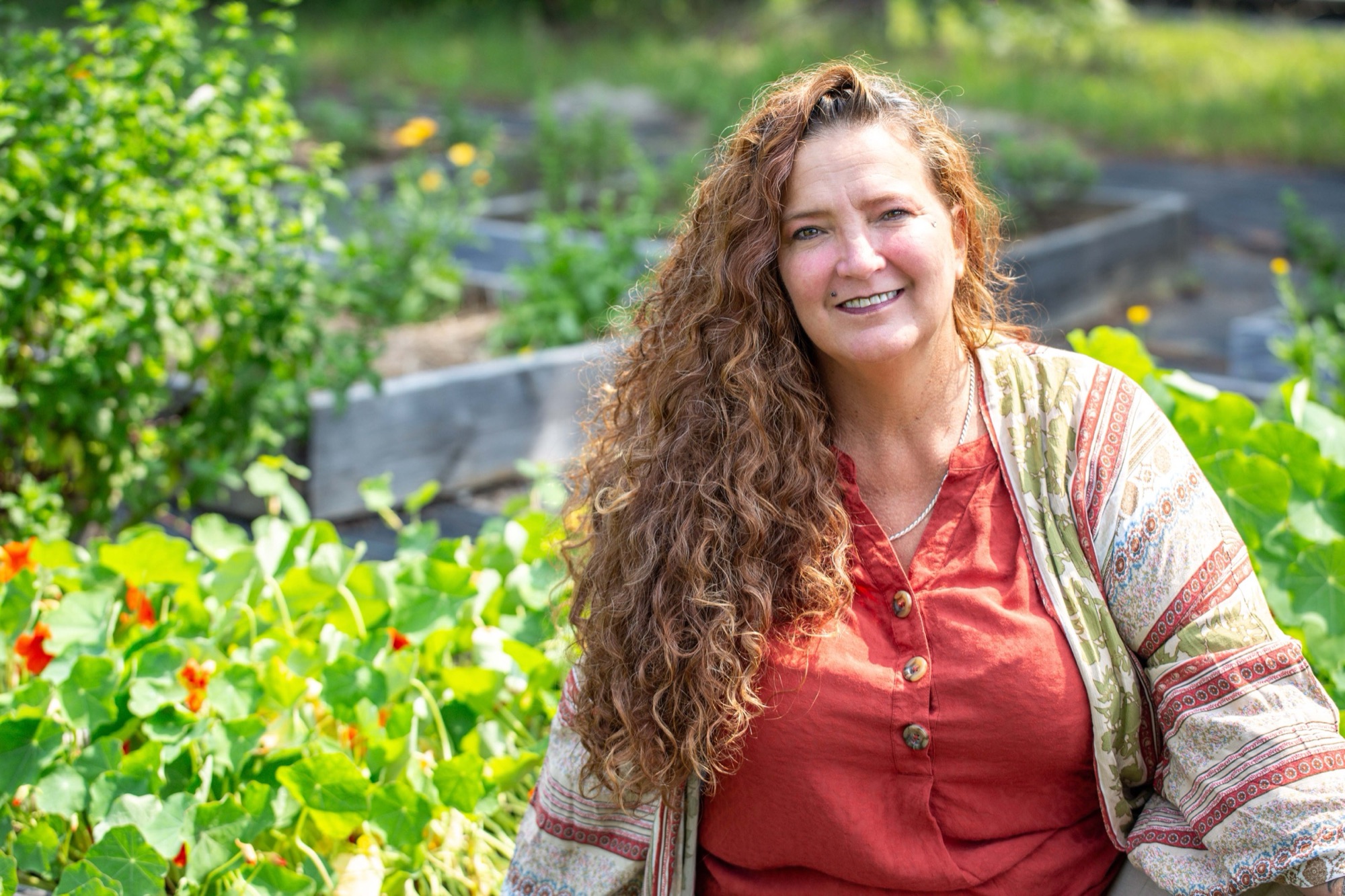 Linda, a 2024 Benevolence Farm alumna, in the farm garden
