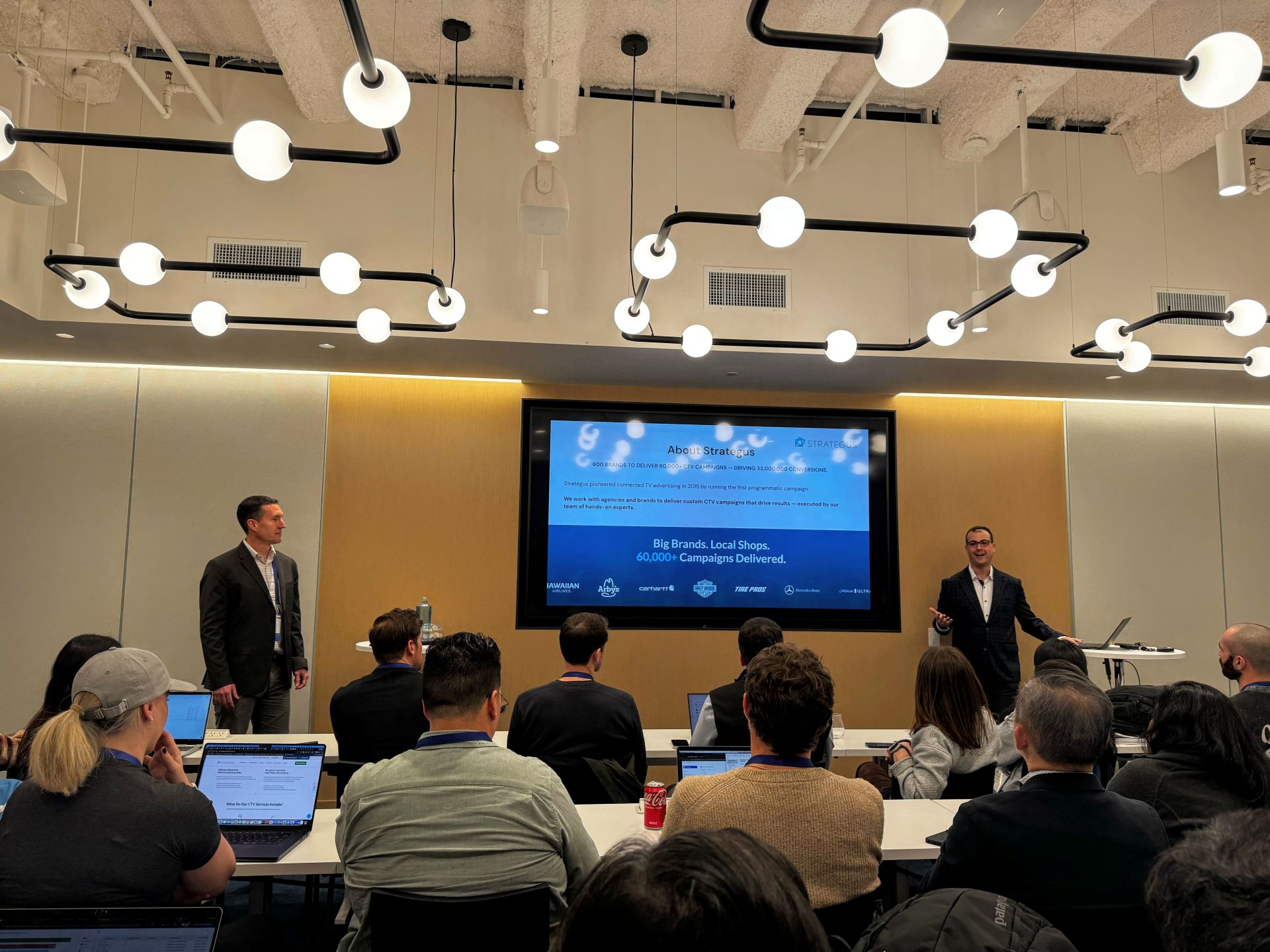Adam Roderick and Mark Sussman presenting MyReportPortal on stage at the inaugural Sigma Workflow conference