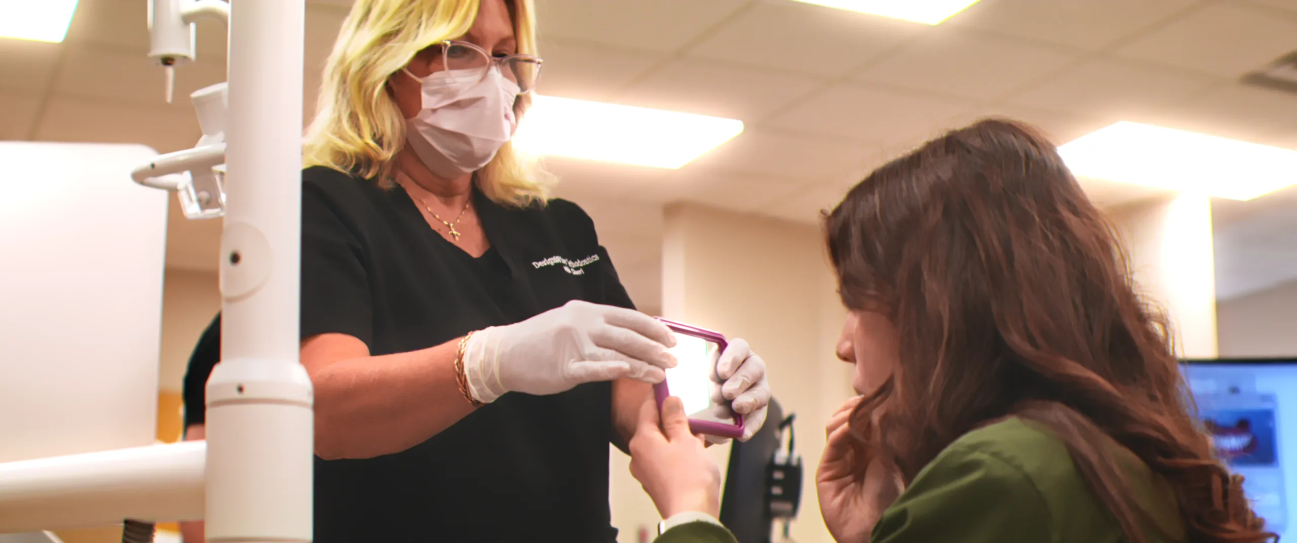 A DesignWise team member explaining care to a patient