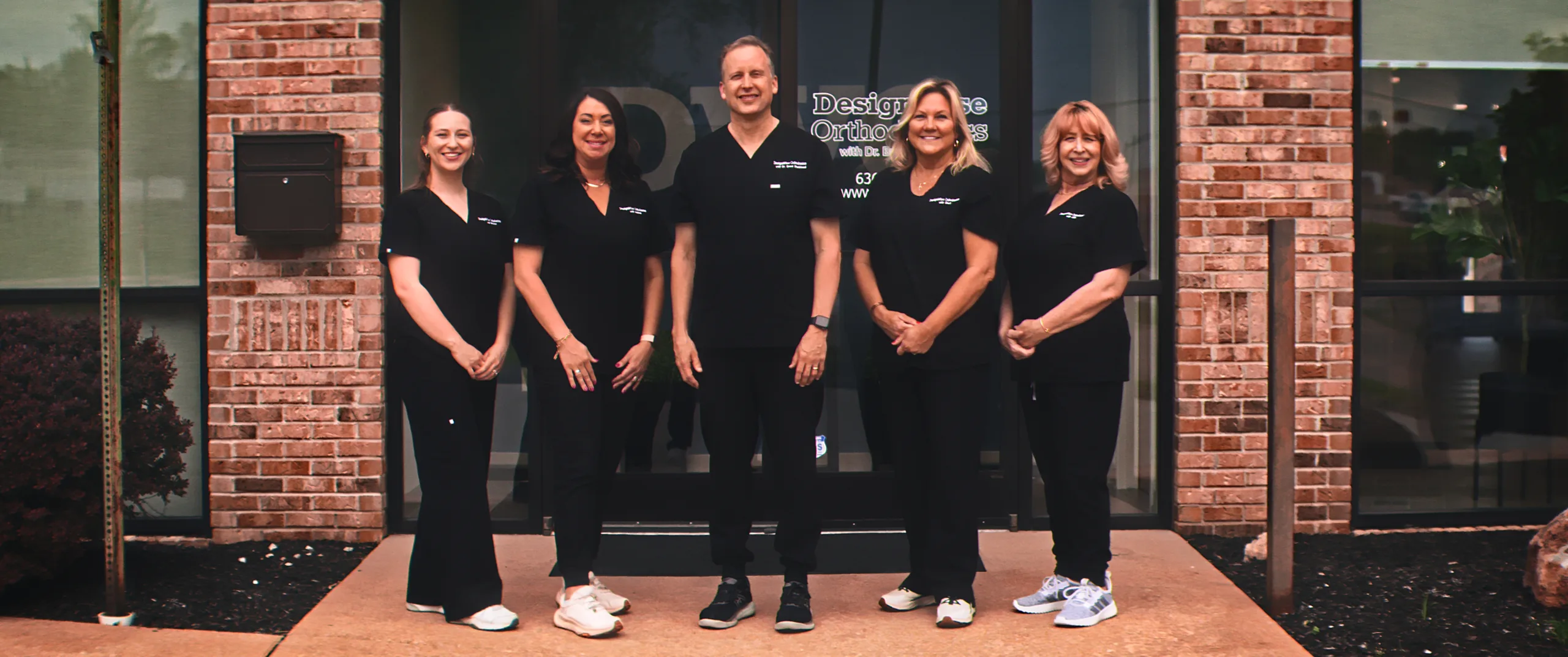 The DesignWise team standing outside the practice entrance