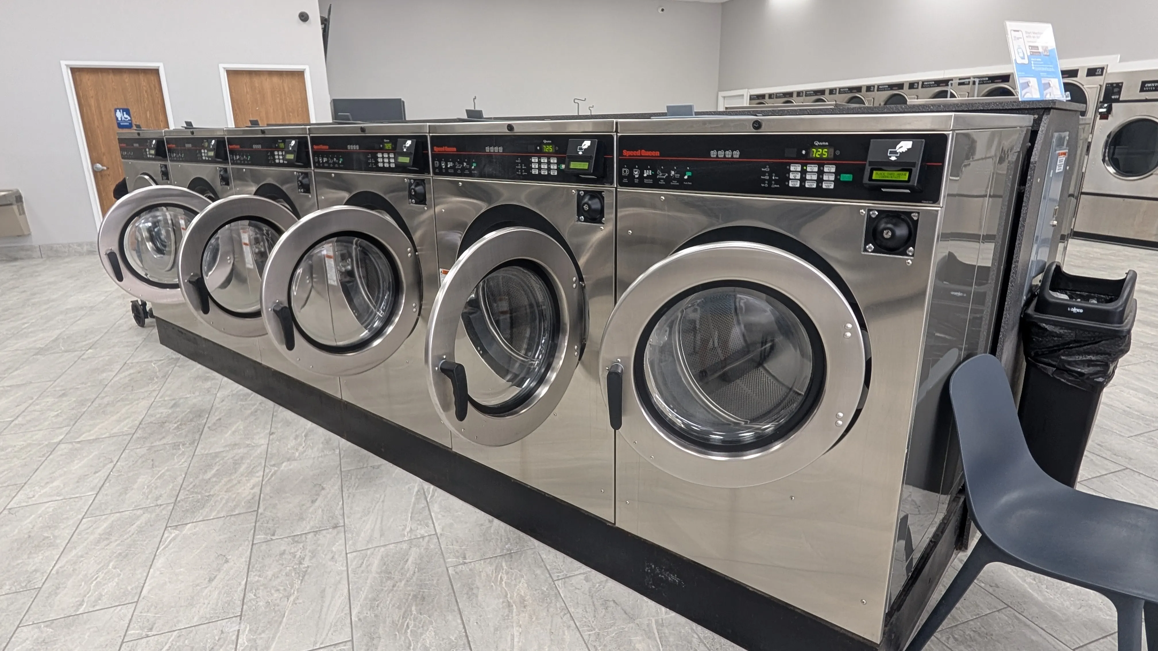 Row of stainless Speed Queen front-load washers at Lafayette Laundromat