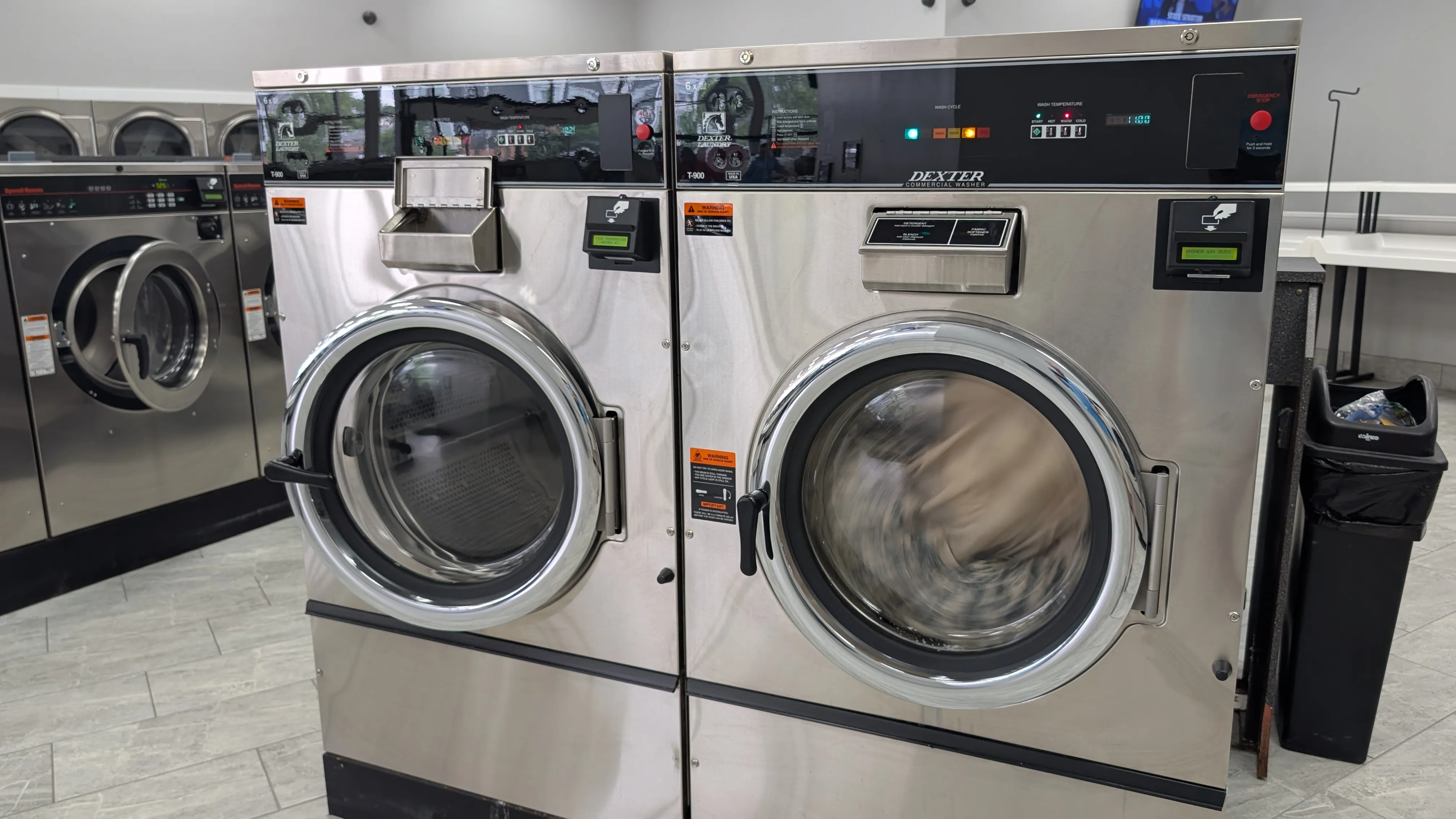 Two Dexter T-900 washers, one running a load