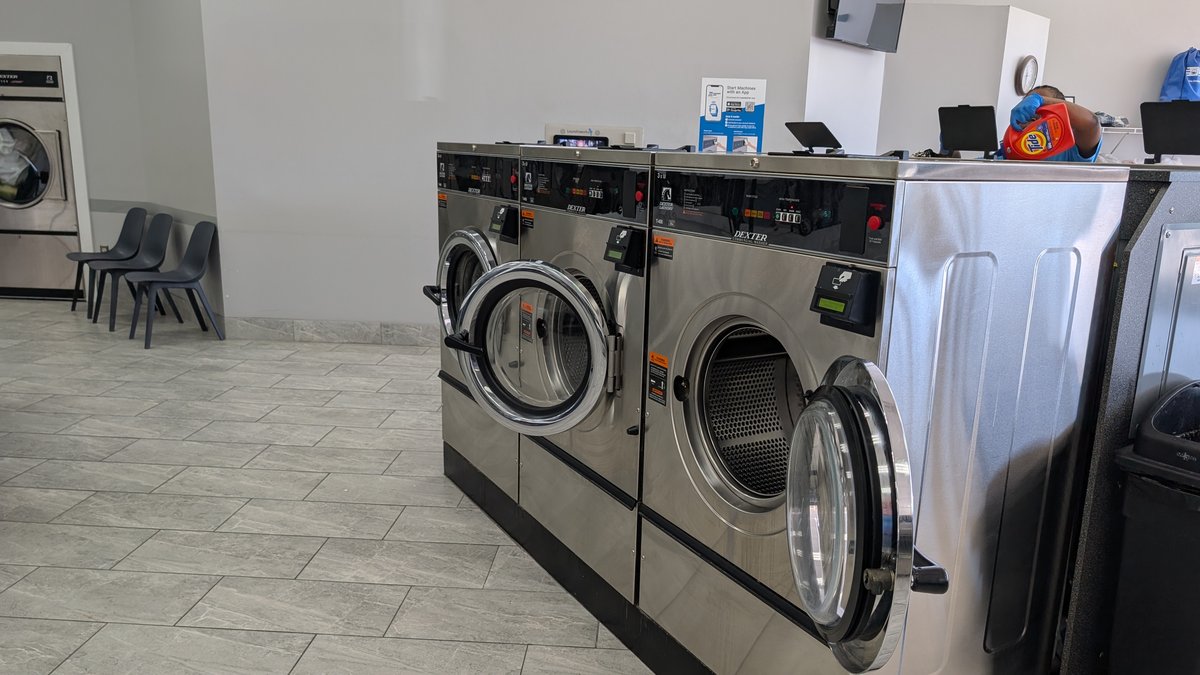 Dexter washers with an attendant working at the service counter