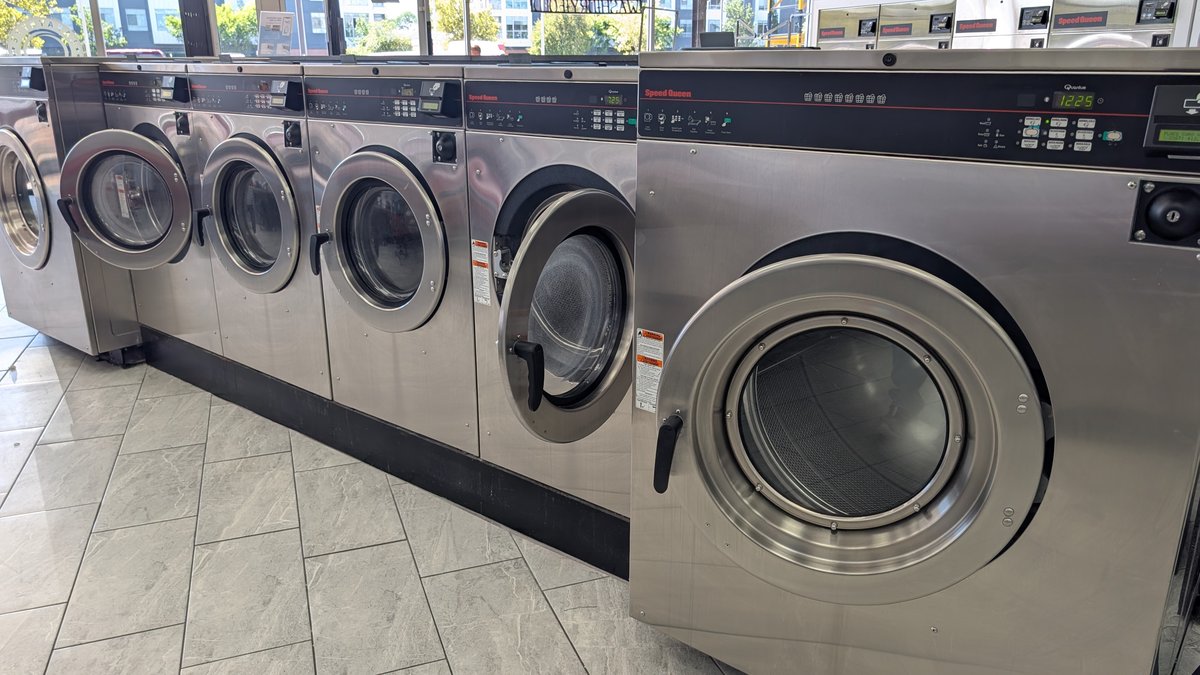 Angled row of Speed Queen washers along the windows