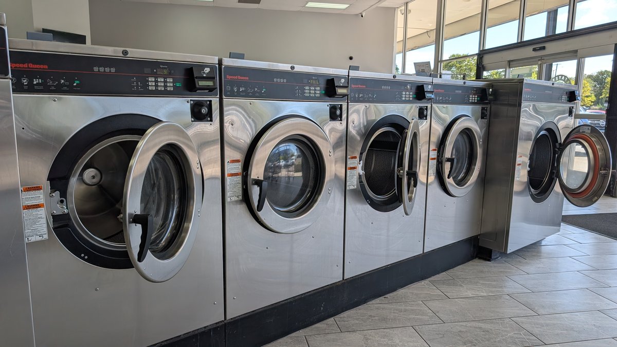 Speed Queen washers with open doors near the storefront windows