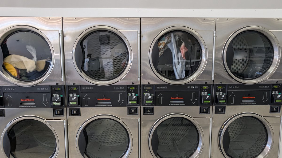 Bed sheets tumbling in a Speed Queen stack dryer