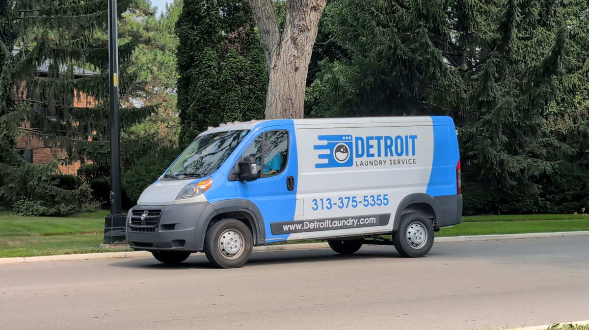 Detroit Laundry Service delivery van parked on a Detroit street