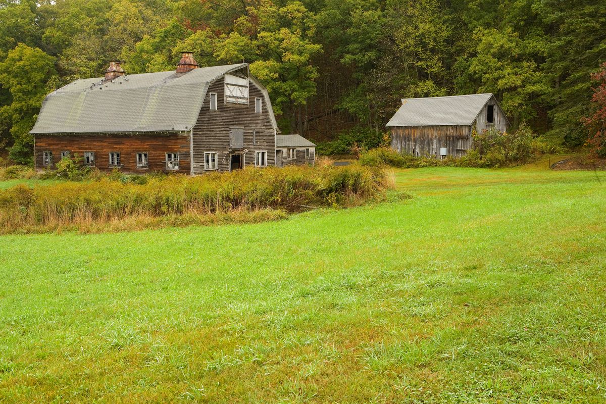 Weathered family barn on a green rural property