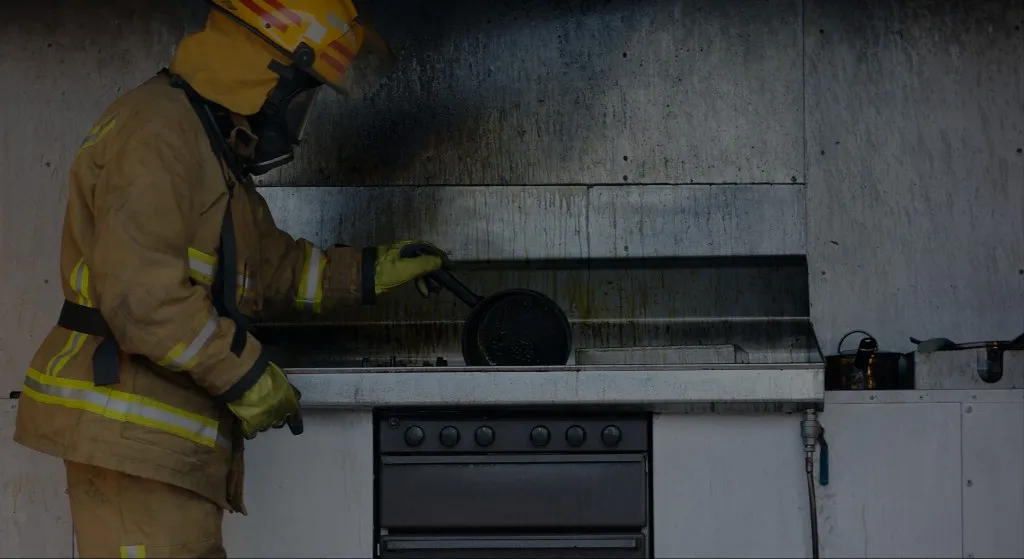 Firefighter inspecting a kitchen after a fire
