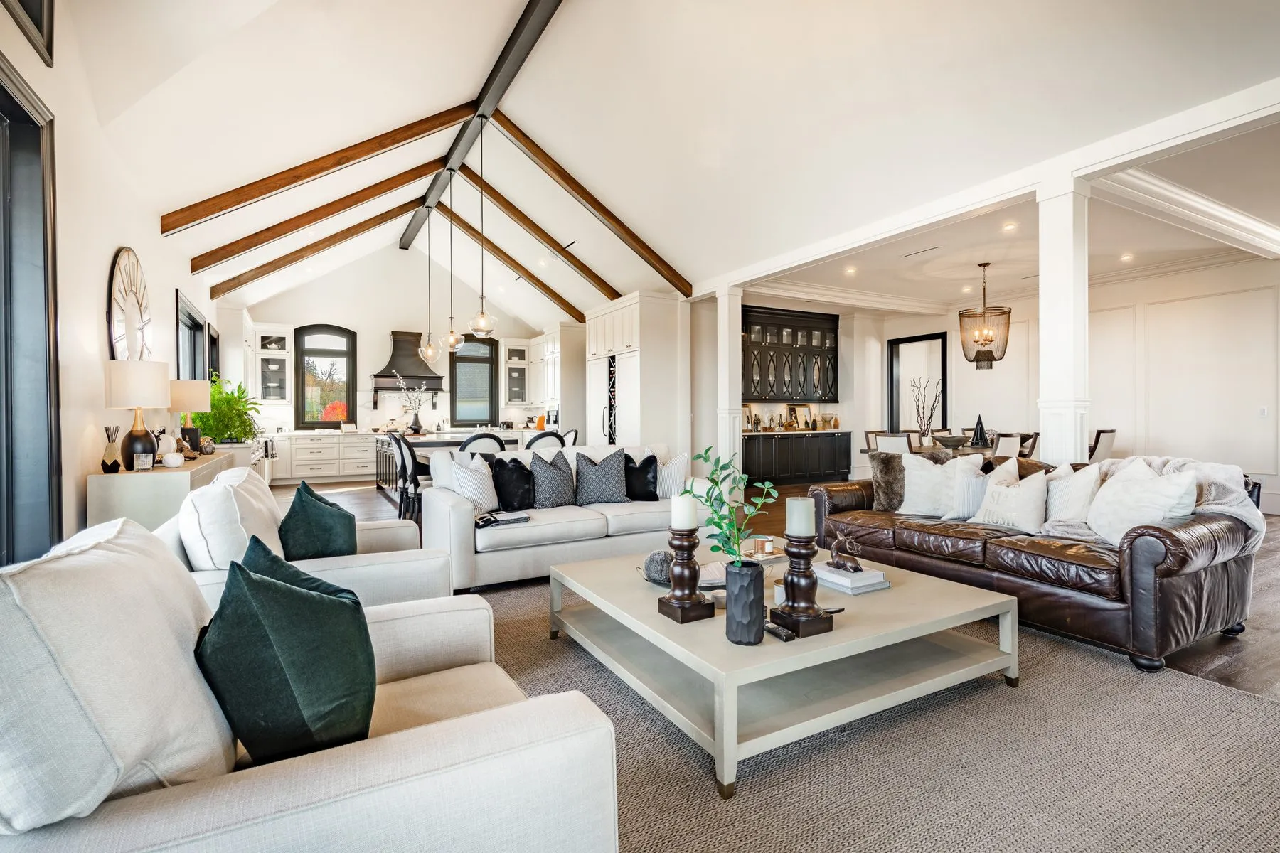 Restored open-concept living room and kitchen in Jacksonville with vaulted wood-beam ceiling