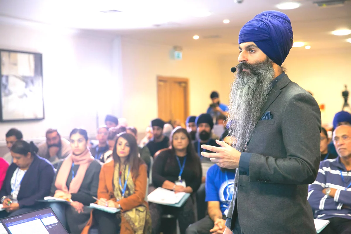 A Nanak Naam speaker leading a workshop with an audience.