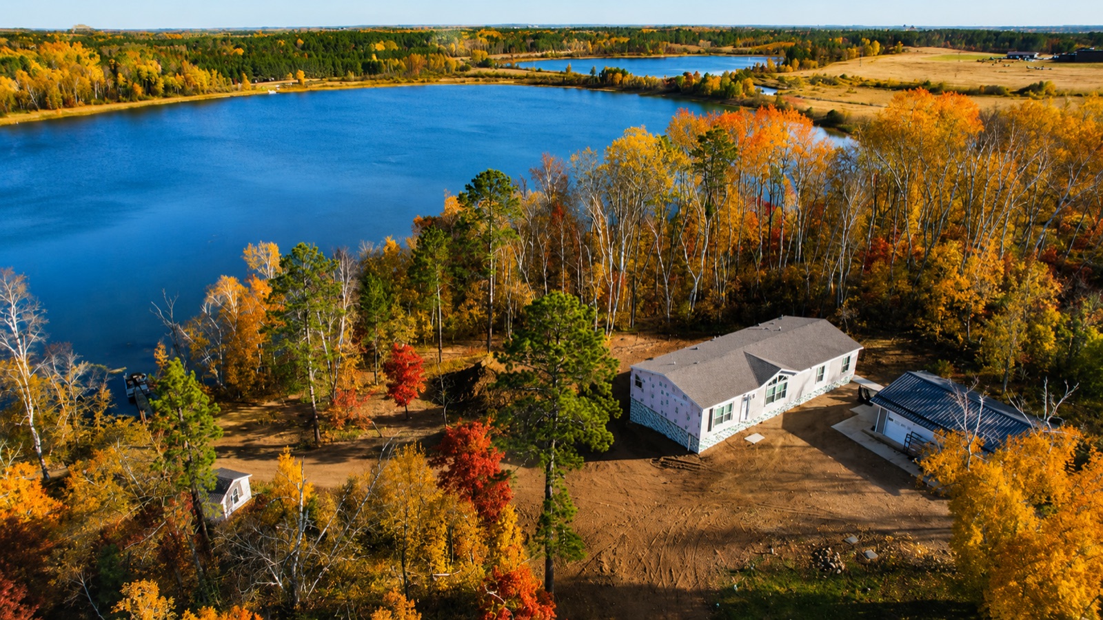 A modular home set on a basement, lakeside in northern Minnesota fall color