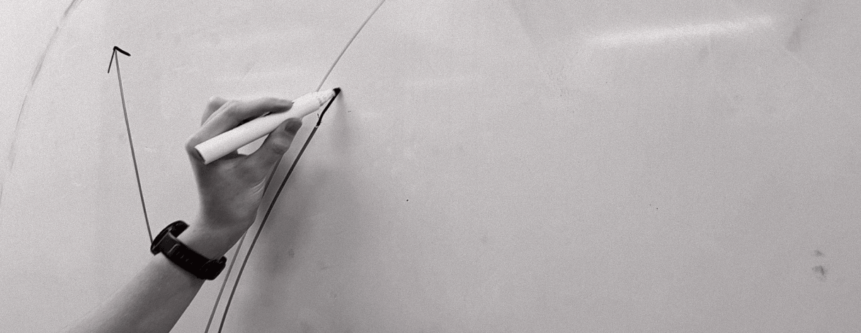 Hand drawing arrows on whiteboard