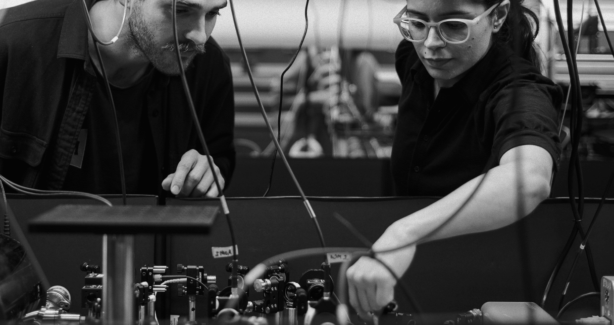 Man and woman looking into a computer