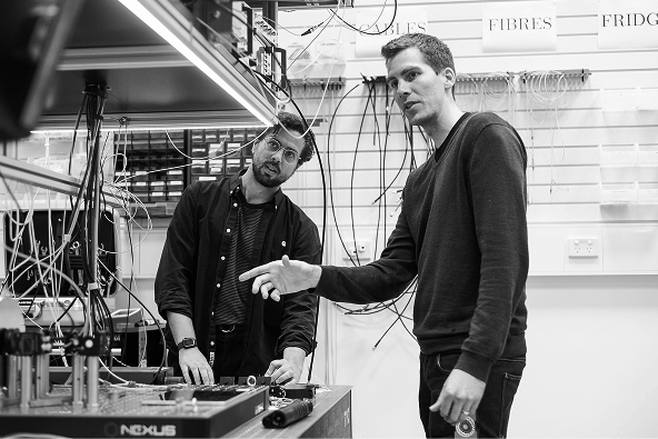 Photograph of two men looking at hardware