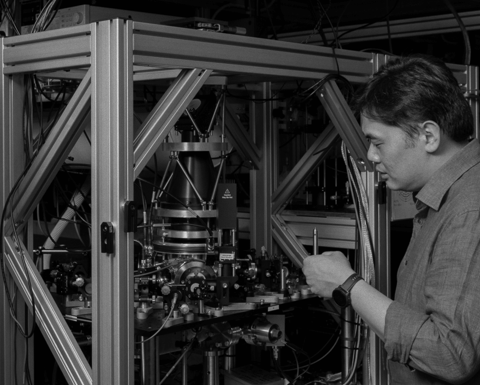 Photograph of a man looking at quantum computing equipment
