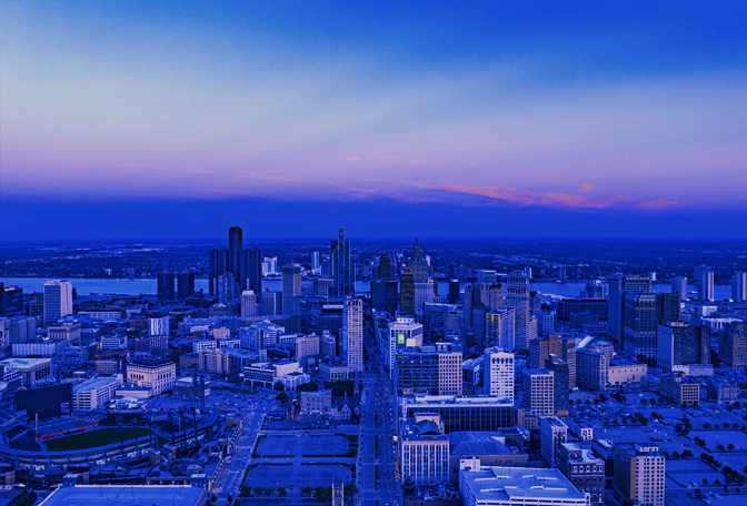 Photo of the Detroit skyline with a blue tint.