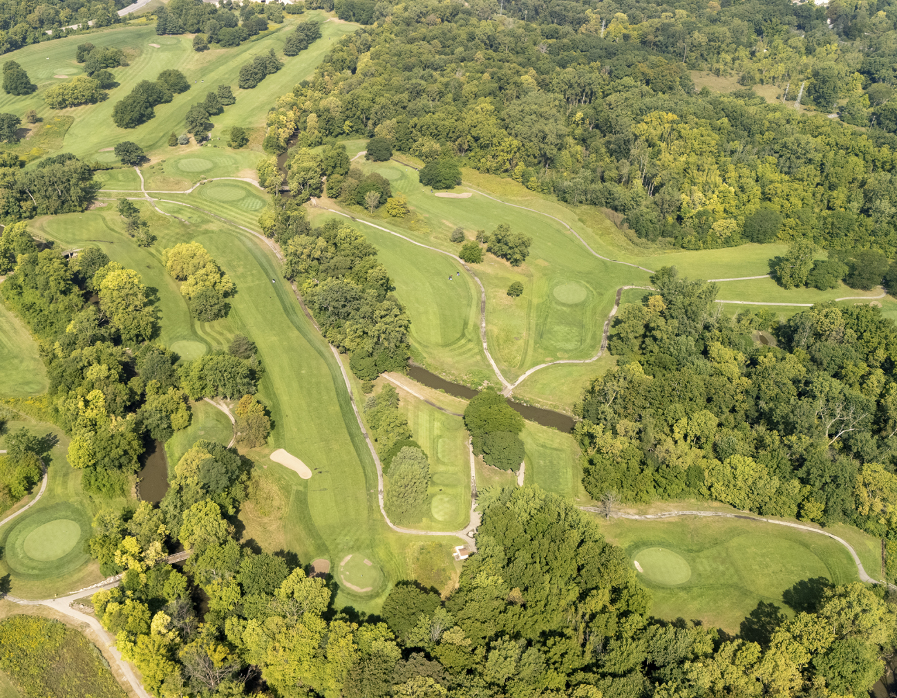 Aerial photo of a landscaped grass and forest area.