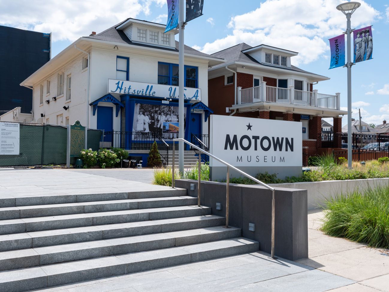 Photo of a white house with blue trim and accents, and a sign in front that reads "Motown Museum."