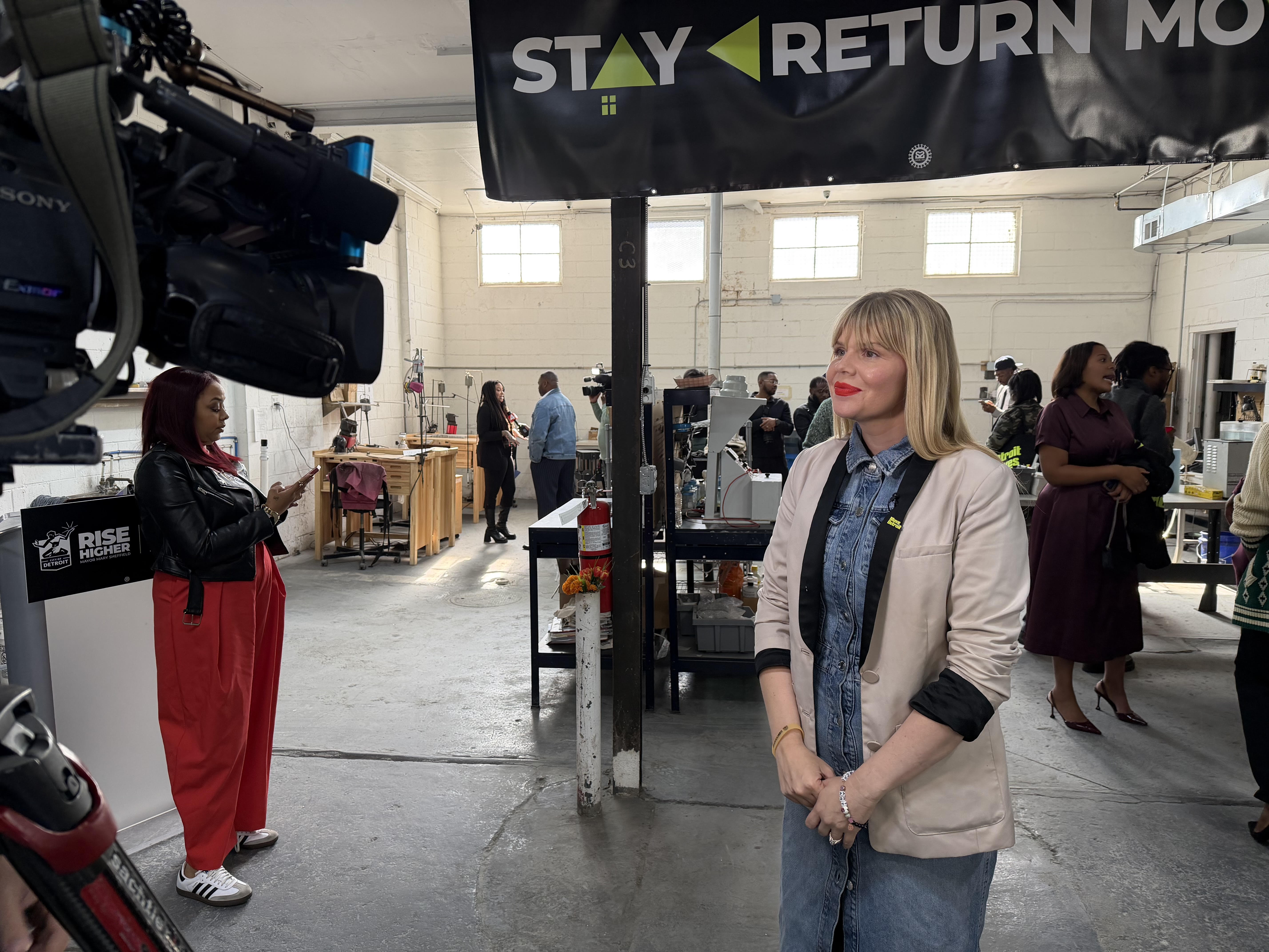 A photo of Hilary Doe being recorded at an event.